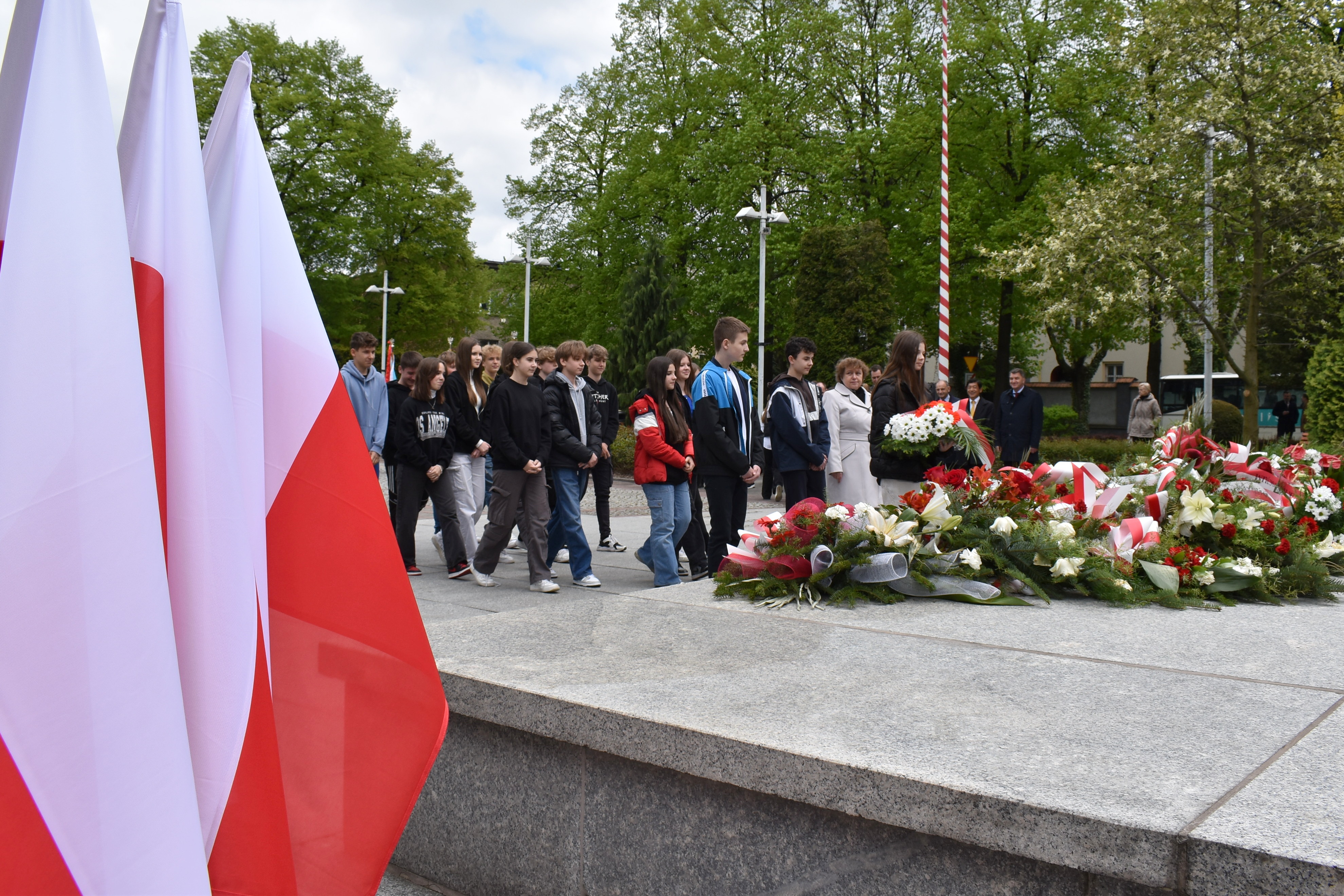 Młodzież jednej z oświęcimskich szkół składa wiązanki kwiatów na płycie Grobu Nieznanego Żołnierza w Oświęicimiu