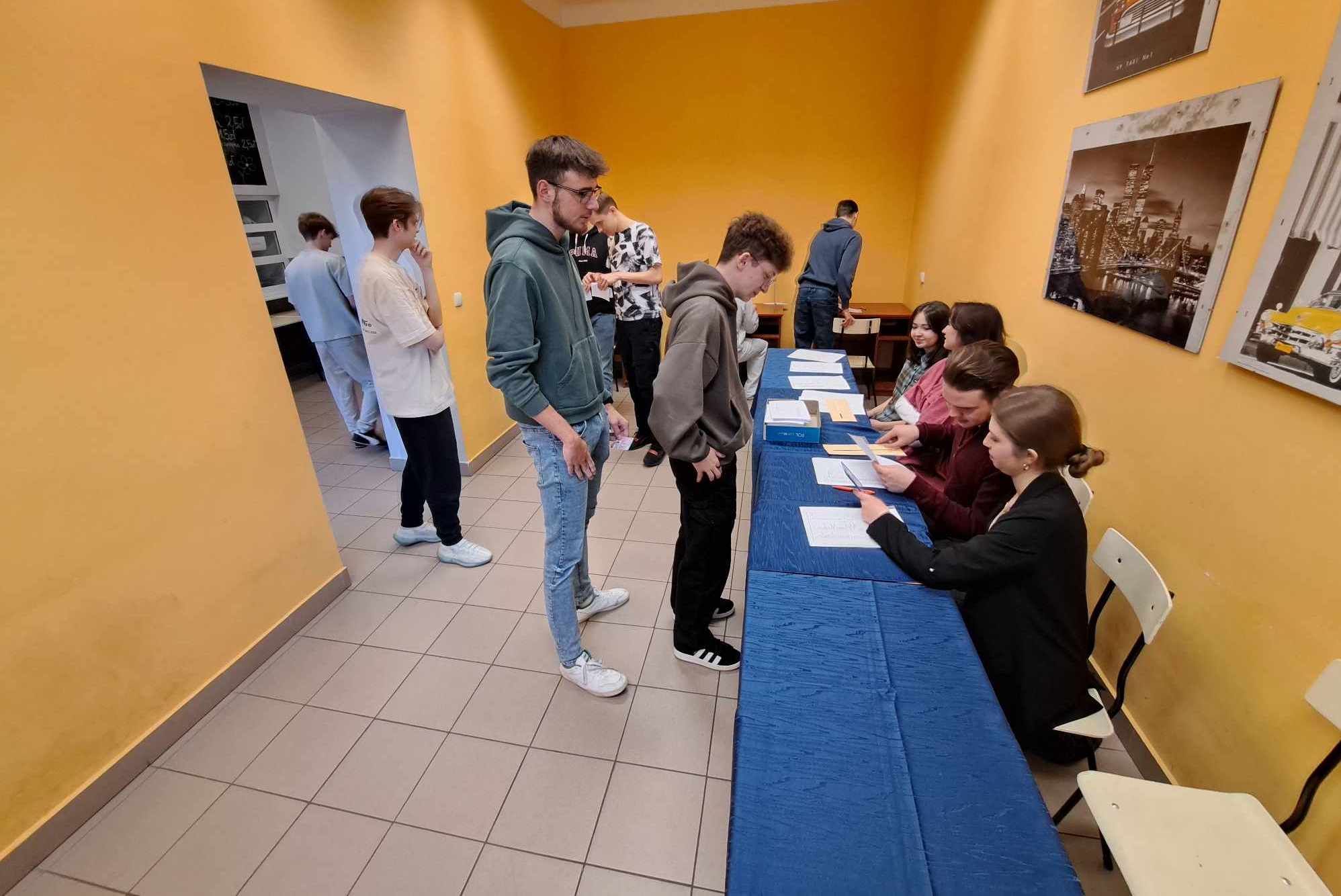 Osoby stojące w kolejce do pobrania kart do głosowania