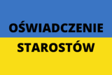 Na niebiesko-żółtej fladze Ukrainy czarny napis "oświadczenie starostów". 