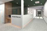 wizualicja centrum diagniostycznego, na pierwszym planie lada z napisem "rejestracja".
